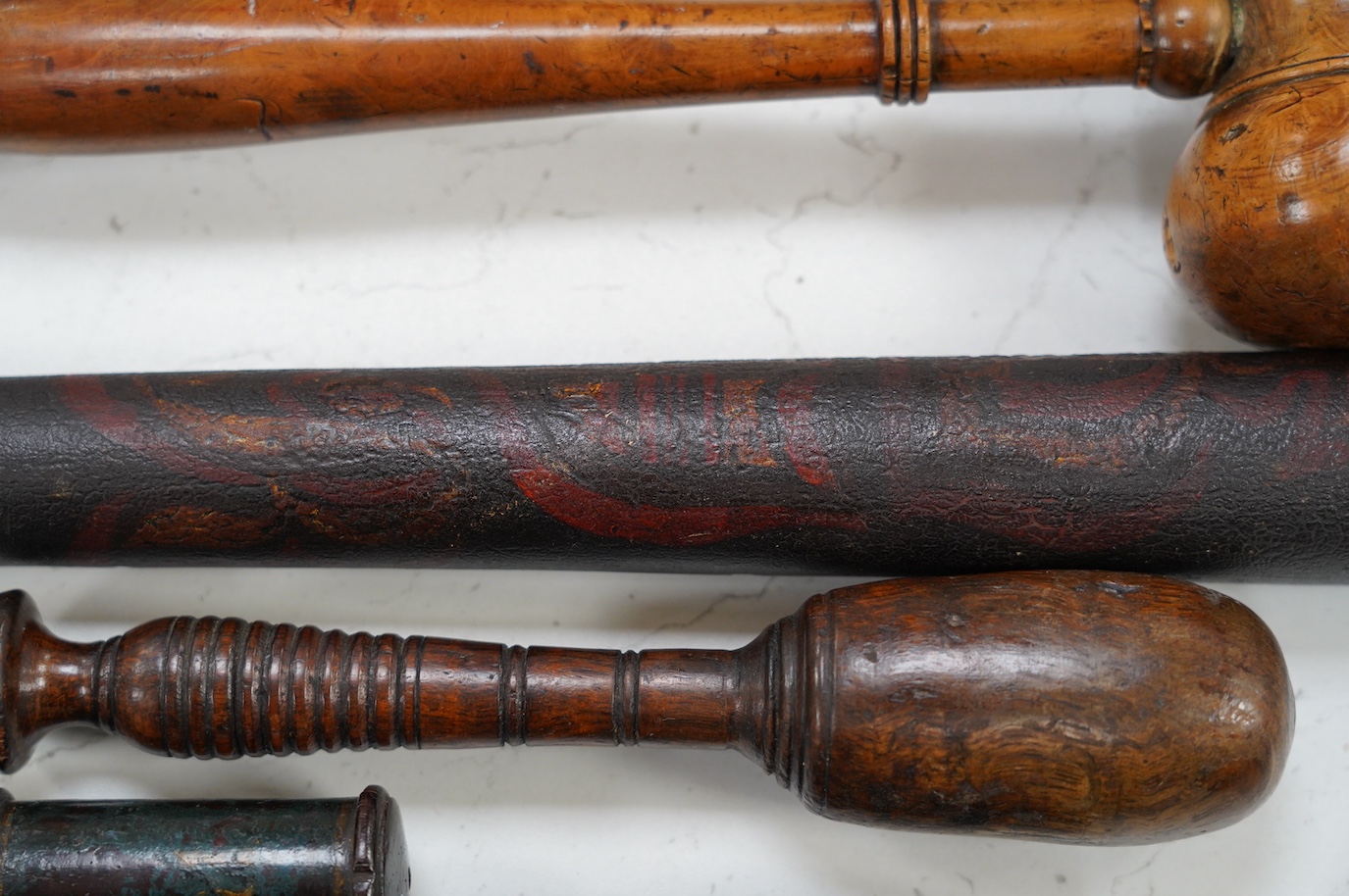 A large fruitwood gavel, a truncheon, a lead-weighted cosh and two others, longest 42cm. Condition - fair